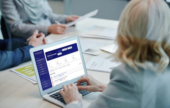 mockuuups-lady-at-a-conference-table-using-a-macbook-air-mockup